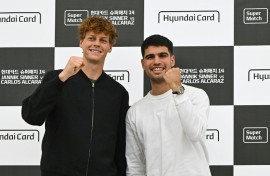 Italy's Jannik Sinner (L) and Spain's Carlos Alcaraz pose for a photo on the eve of their match