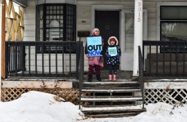 Children hold signs along the route of the protest march in Minneapolis