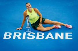 Aryna Sabalenka celebrates with the trophy after winning the women's singles final against Marta Kostyuk at the Brisbane International