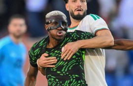 Osimhen holds off Ramy Bensebaini during Nigeria's quarter-final win over Algeria in Marrakesh