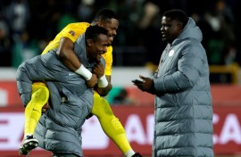 Nigeria reserve goalkeeper Amas Obasogien carries Stanley Nwabali, who saved two penalties in a shoot-out victory over Egypt in the Africa Cup of Nations third place play-off.