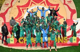 Senegal players celebrate with the trophy after beating hosts Morocco in the final to win the Africa Cup of Nations for the second time in their history