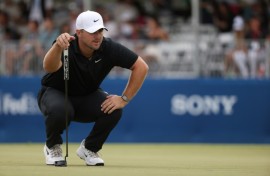 Chris Gotterup lines up a putt on the 18th green before completing his victory at the Sony Open in Hawaii