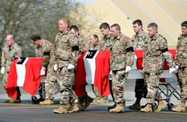 The coffins of two Danish soldiers killed in a suicide attack in Gereshk, Afghanistan, are carried out of a military transport plane at Skrydstrup Airport in Jutland, Denmark on March 23, 2008