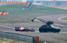 A camera crew film Charles Leclerc in the new SF-26