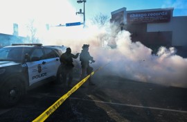 Tear gas is deployed by law enforcement in Minneapolis as demonstrators gather near the site where officials say a man was shot by federal agents
