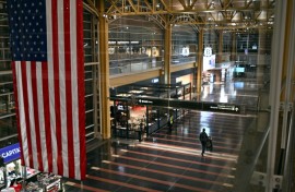 A passenger walks through the check-in area of Ronald Reagan National Airport in Washington, DC, on January 24, 2026, after thousands of flights across the United States were cancelled due to a winter storm