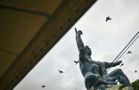 Released doves fly past the "Peace Statue" in Nagasaki, part of a ceremony to mark the 80th anniversary on August 9, 2025 of the world's last nuclear attack