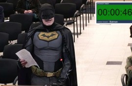 This frame grab from a January 27, 2026, video from a City of Santa Clara, California council meeting shows a man dressed as Batman berating officials in the city