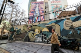 Anti-US and anti-Israel banners hang on a building in Palestine Square in Tehran