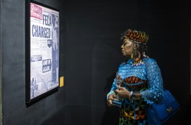 Yeni Kuti, Fela's daughter, looks at a headline on Fela Kuti at the Afrobeat Rebellion exhibition in 2025