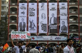 Campaign banners hang on a building's facade during an election rally of the Bangladesh Nationalist Party ahead of the country's general election. Authorities say the scale of online manipulation -- including sophisticated AI-generated images --  has become so severe that a special unit has been created to curb false content