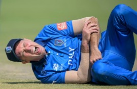 Italy captain Wayne Madsen grimaces in pain after dislocating his shoulder while fielding against Scotland