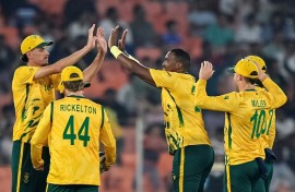 South Africa's Lungi Ngidi (C) celebrates with teammates after taking the wicket of Canada's Yuvraj Samra