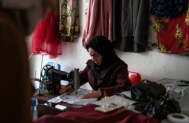 Rahima Alavi embroiders a scarf at her boutique in Bamiyan
