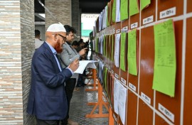 Members of the media look at documents of preliminary election results at the Election Commission office in Dhaka on February 13, 2026