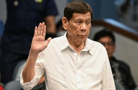 Former Philippine president Rodrigo Duterte takes an oath as he attends a senate probe on the drug war during his administration, in Manila on October 28, 2024