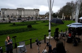 Members of the media gather outside Buckingham Palace in London after the arrest of former prince Andrew