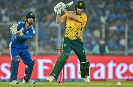 David Miller plays a shot as India wicketkeeper Ishan Kishan watches