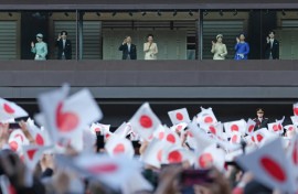Japan's Emperor Naruhito (centre L), Empress Masako (centre R), and other members of the Imperial Family wave to well-wishers during a public audience celebrating the Emperor's 66th birthday, at the Imperial Palace in Tokyo