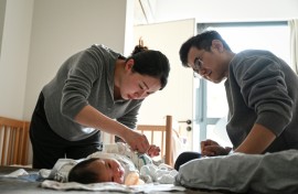 Wang Yifan (left) says paediatrician avatars helped answer questions about her baby, reducing trips to hospital