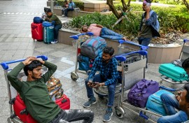 Stranded passengers wait at the departure terminal in Mumbai on March 1, 2026 after India's two largest private carriers IndiGo and Air India suspended flights to all destinations in the Middle East