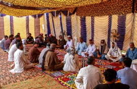 Mourners gather to offer condolences after the death of Pakistani national Muzaffar Ali, who was killed in Dubai amid the ongoing Middle East war, after his funeral in Jamshoro, in Sindh province