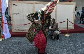 A crate holding the Djidji Ayokwe, or 'talking drum', looted by French colonial troops from Ivory Coast in 1916, arrived home in Abidjan