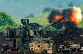 An Israeli artillery gun fires rounds towards southern Lebanon