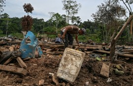 Farmer Jose Pena looks for belongings amid rubble after a bomb dropped by the Ecuadoran army in the Lago Agrio region of Ecuador on the border with Colombia