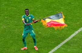Idrissa Gueye waves the Senegal flag after his side beat Morocco on the field in the in the Africa Cup of Nations final in January