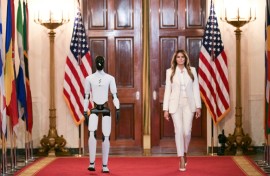 US First Lady Melania Trump walks with a humanoid robot as she arrives for the Fostering the Future Together Global Coalition Summit in the White House