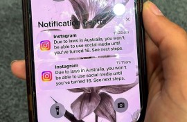 A teenager holds a phone displaying a message from social media platform Instagram after the account was locked for age verification in Australia