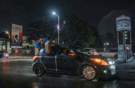 Congolese supporters celebrate in the rainy streets of Kinshasa