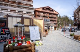 Candles and flowers left by Le Constellation bar in Crans-Montana