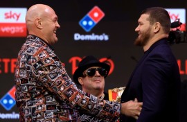 Britain's two-time former world heavyweight champion Tyson Fury (L) faces off with Russia's Arslanbek Makhmudov during a press conference ahead of their bout in London