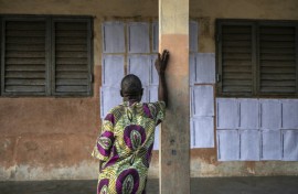 A voter looks for his name on the electoral roll at a primary school serving as a polling station in Cotonou, Benin