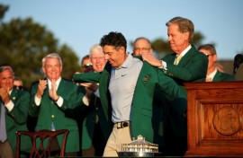 Rory McIlroy dons the green jacket after winning his second Masters in a row, forcing Augusta National chairman Fred Ridley to do the honor usually given to the prior year's champion