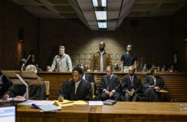 Kemi Seba (centre) was arrested alongside his son and a South African national