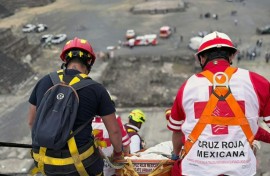 This handout picture released by the Mexican Red Cross shows the removal of the body of a Canadian woman who was shot dead at Teotihuacan by a man who later killed himself