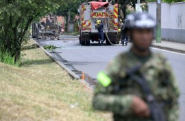 Colombian firefighters and soldiers deployed after a bomb explosion next to a military base in Cali