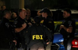 FBI agents are seen outside a residence associated with the alleged White House Correspondents' Dinner shooter in Torrance, California, on April 25, 2026