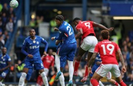 Nottingham Forest striker Taiwo Awoniyi (2nd R) heads the opening goal against Chelsea
