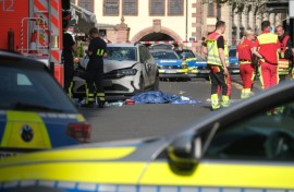 Members of the emergency services work at the scene where several people were injured during an incident involving a car in the city centre in Leipzig, eastern Germany