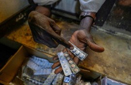 A person receives free medication in Sudan's capital. In Blue Nile to the south, displaced people have reported shortages of medicine and food