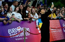 Austrian singer Johannes Pietsch, aka JJ poses on the turquoise carpet for the opening ceremony of the Eurovision Song Contest 2026 at the City Hall Square in Vienna, Austria