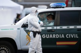A Spanish civil guard wears a protective suit as the MV Hondius arrived at the industrial port of Granadilla de Abona on Tenerife on May 10, 2026