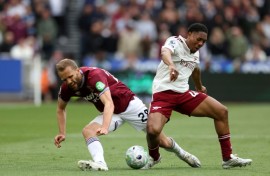 Arsenal's Myles Lewis-Skelly (R) tackles West Ham's Tomas Soucek (L) during the Gunners' 1-0 Premier League win at the London Stadium