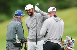 Top-ranked defending champion Scottie Scheffler, center, talks with caddie Ted Scott, right, and swing coach Randy Smith during a practice round at Aronimink ahead of the 108th PGA Championship