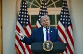 US President Donald Trump gestures prior boarding Air Force One at Joint Base Andrews en route to China